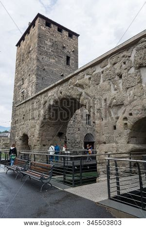 Aosta, Italy - July 20, 2014: Tourists Exploring Old Roman Ruins In Aosta