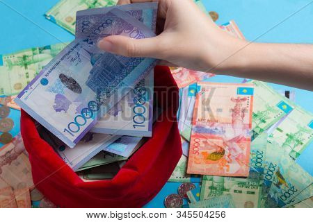 Person Pulls The Money Out Of The Red Bag. Kz. Kazakhstan, Kzt. Pulling A Lot Of Money Out Of The Ba