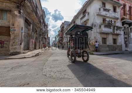Havana, Cuba - May 14, 2019: Bicycle Taxi Driver Riding In The Streets Of Old Havana City During A V