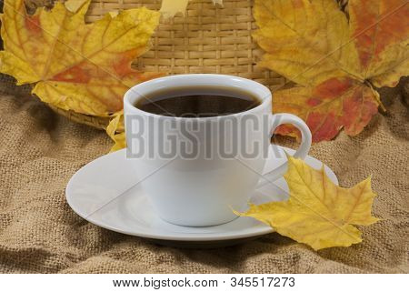 Coffee Mug With Autumn Fall Leaves On Autumn Background. Stock Photo, Close Up