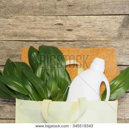 Green Leaves In A Bag With Detergent On The Background Of Bathing Linen. Bioorganic Washing Product.