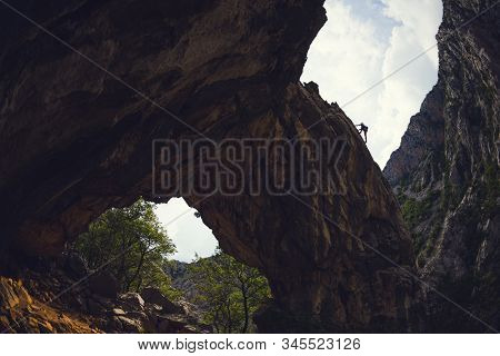 Rock Climbing And Mountaineering In The Paklenica National Park. A Woman Overcomes A Challenging Cli