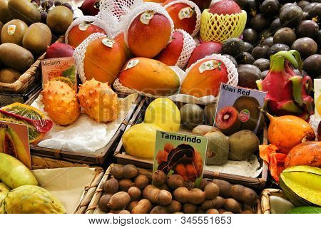 Oporto, Portugal- December 31, 2019: Colorful And Tasty Tropical Fruits For Sale At A Market Stall A