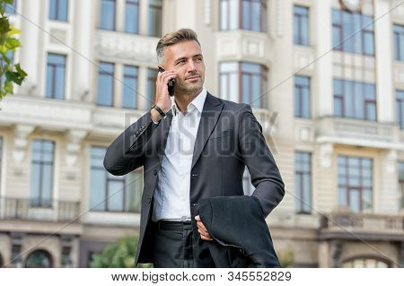 Phone Keeps Him Connected. Businessman Talk On Mobile Phone. Handsome Man With Cell Phone Outdoor. P