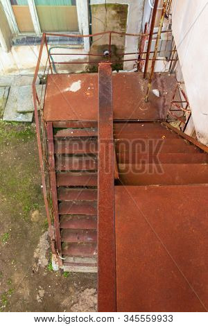 Metal Stairs. Abandoned Urban Background Full Of Rusty Texture. View Downside