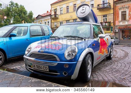 Uzhhorod, Ukraine - 14 Jul, 2013: Red Bull Mini Cooper Publicity Car With A Can Of Energy Drink Behi