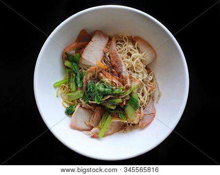Top View Of Egg Noodle With Bbq Pork, Shrimp Wonton Topped With Sliced Scallion In White Bowl Isolat