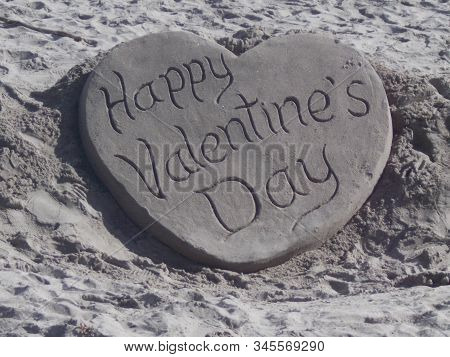 Happy Valentines Day Heart Sand Sculpture On Beach