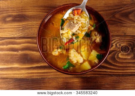 Kharcho Soup With Meat And Rice On Wooden Table. Top View