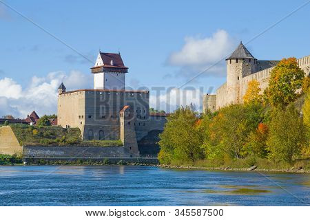 Estonian Herman Castle At The Russian Ivangorod Fortress In Golden Autumn. The Border Of Estonia And