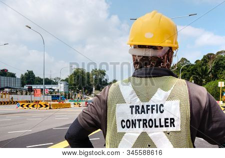 Traffic Controller Worker Stand At The Road Side