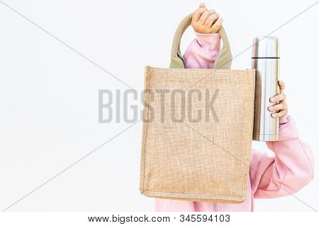 An Asian Girl Is Using A Cloth Bag In Place Of A Plastic Bag In The Concept Of Reducing Plastic Wast