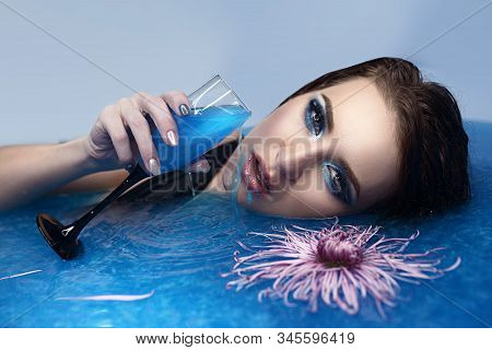 Woman Relaxing In Round Outdoor Bath With Tropical Flowers. Organic Skin Care In Kawa Hot Bath In Lu