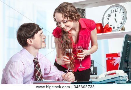 Boss Drinks Champagne With His Secretary In Valentines Day At The Office. A Young Man Flirts With Yo