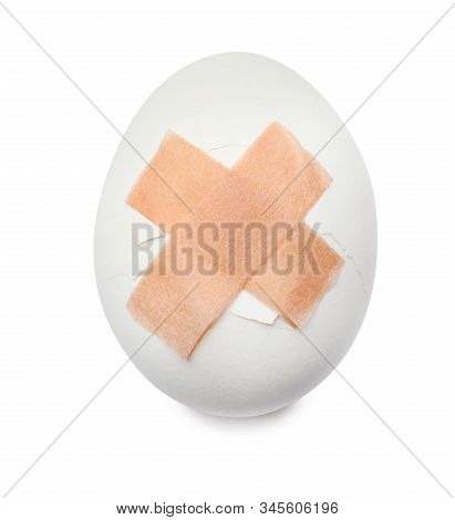Cracked Egg With Sticking Plasters Isolated On White, Top View