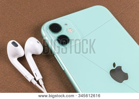 Helsinki, Finland, January 13, 2020: Apple Iphone 11 Camera And Headphones Close Up On Office Desk.