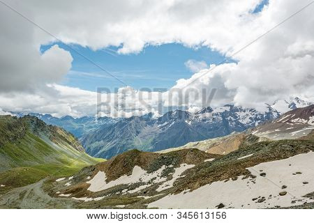 Spectacular Mountain Panorama With Clouds Covering The Sky.