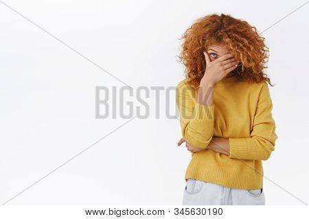 Embarrassed Attractive Modern Redhead Curly Girlfriend In Yellow Sweater Blushing As Boyfriend Behav