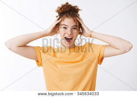 Wild Emotive Energized Good-looking Young 20s Redhead Girl Messy Curly Hairbun Wearing Orange T-shri