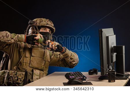 Military In Uniform Sitting At A Computer Are Cyberwar, Playing, Throwing A Grenade