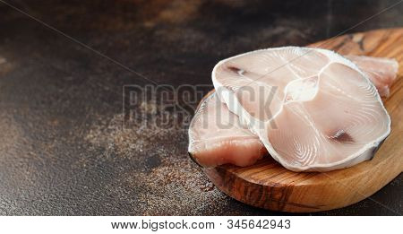 Two Shark Steak On A Dark Board Close Up