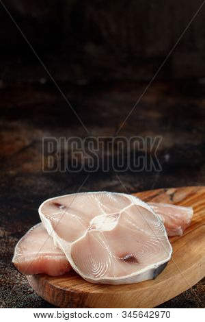 Two Shark Steak On A Dark Board Top View