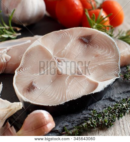Two Shark Steak With Vegetables And Herbs On A Dark Board
