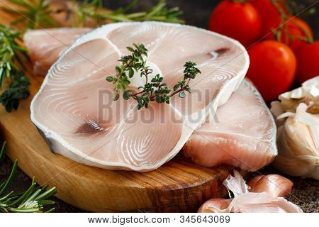 Two Shark Steak With Vegetables And Herbs On A Dark Board