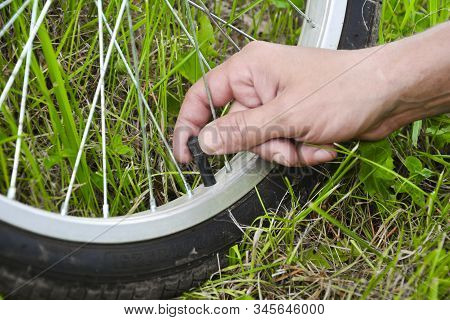 Inflating The Tire Of A Bicycle. Pumping Air Into A Wheel Of Bike. Home Maintenance Of Bike. Bicycle