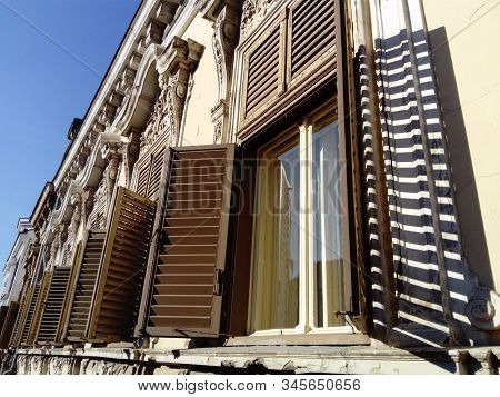 Beautiful Facade Of An Old Building In Serbia. Wooden Shutters Give The House A Special Charm. Windo