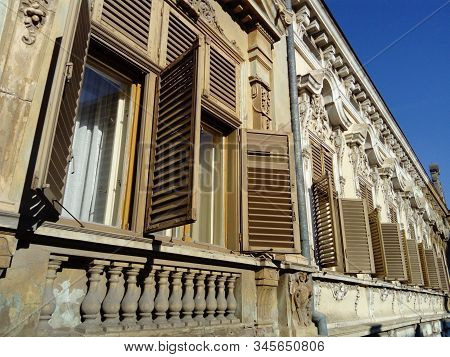 Beautiful Facade Of An Old Building In Serbia. Wooden Shutters Give The House A Special Charm. Windo