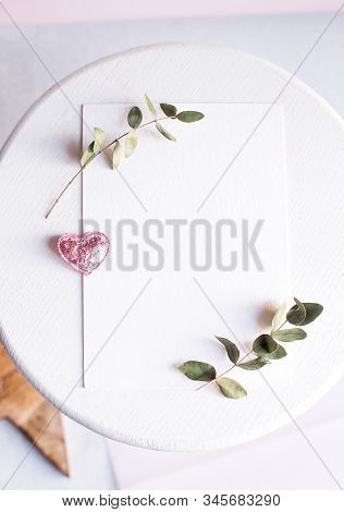Background With Copy Space Blank On White Table With Glitter Heart, Eucalyptus Branch, Flowers And L