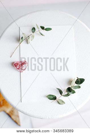 Background With Copy Space Blank On White Table With Glitter Heart, Eucalyptus Branch, Flowers And L