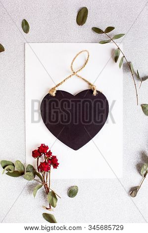 Background With Copy Space Blank On Table With Black Heart, Eucalyptus Branch, Roses Flowers And Lea