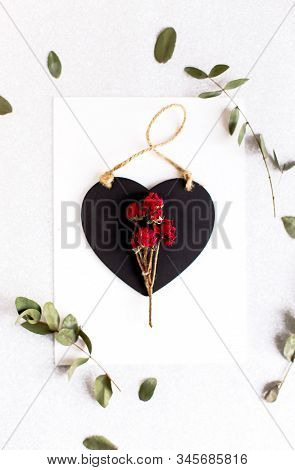 Background With Copy Space Blank On Table With Black Heart, Eucalyptus Branch, Roses Flowers And Lea