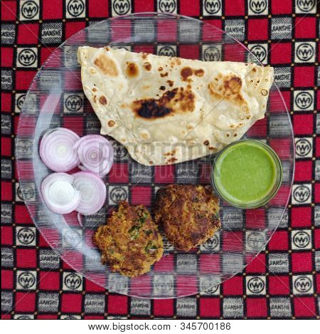 Hydrabadi Kawab Paratha With Green Chili Sauce & Onion On Transparent Plate. Kabab An Irani Dish Wit