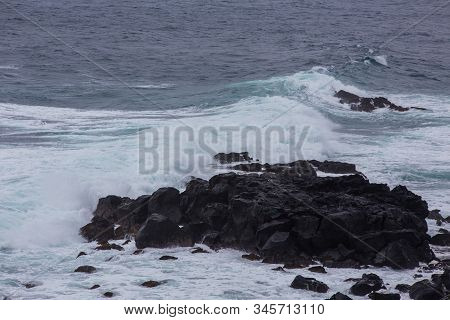 Beautiful Nature Scene Of Sea Wave Hitting On The Black Stone Shoreline At Jeju Island, South Korea.