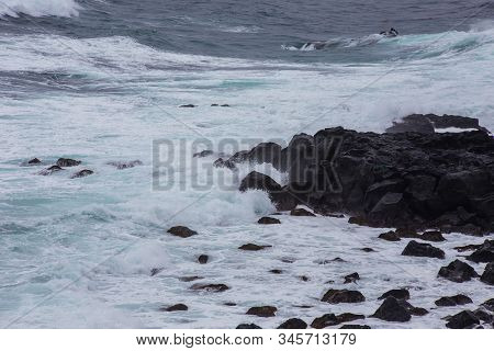 Beautiful Nature Scene Of Sea Wave Hitting On The Black Stone Shoreline At Jeju Island, South Korea.