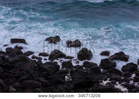 Beautiful Nature Scene Of Sea Wave Hitting On The Black Stone Shoreline At Jeju Island, South Korea.