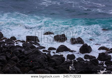 Beautiful Nature Scene Of Sea Wave Hitting On The Black Stone Shoreline At Jeju Island, South Korea.