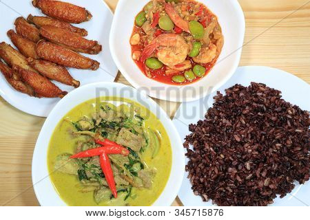 Meal Of Thai Local Food, Green Curry With Beef, Deep Fried Spicy Chicken Wings, Stir Fried Parkia Nu