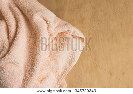 Soft Bath Towel On Wooden Background. Copy Space. Mockup For Design.