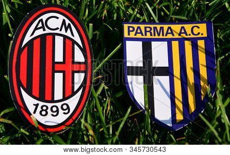 September 6, 2019, Turin, Italy. Emblems Of Italian Football Clubs Milan And Parma On The Green Gras