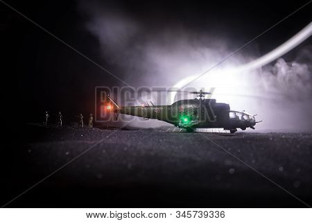 Silhouette Of Military Helicopter Ready To Fly From Conflict Zone. Decorated Night Footage With Heli
