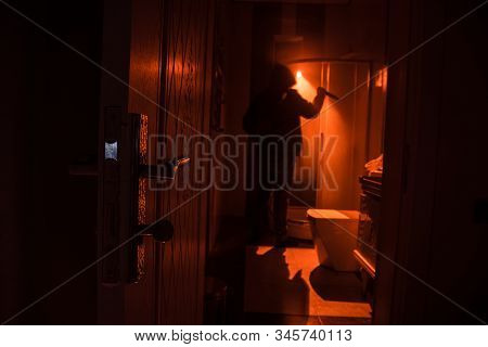 Horror Silhouette Of Person In Window. Scary Halloween Concept Blurred Silhouette Of Witch In Bathro