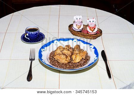 Lunch Or Dinner Of A Bachelor. Plate With Buckwheat And Chicken Meat On A Round Table Covered With A