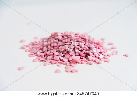 A Lot Of Small Heart-shaped Candies, Piled Up On A Light Background. Pink Pills. The Concept Of Swee