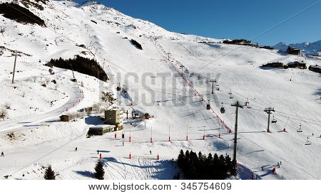 Majestic Winter Aerial Landscape And Ski Resort With Typical Alpine Wooden Houses In French Alps, Le