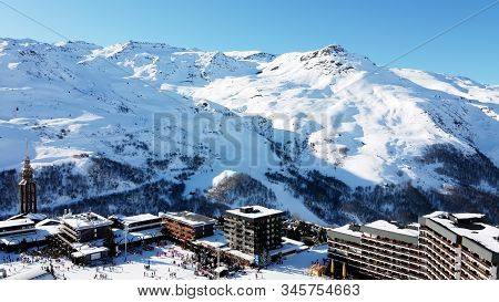 Majestic Winter Aerial Landscape And Ski Resort With Typical Alpine Wooden Houses In French Alps, Le
