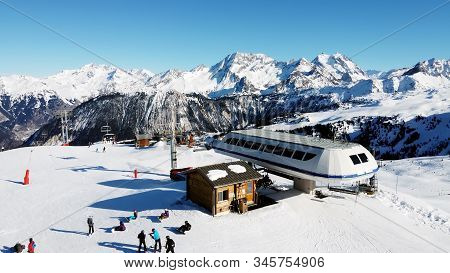 Majestic Winter Aerial Landscape And Ski Resort With Typical Alpine Wooden Houses In French Alps, Le